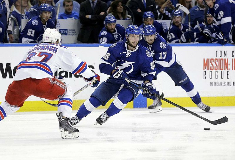 Tampa Bay’s Nikita Kucherov (center) skates toward the goal during the overtime period Wednesday against the New York Rangers. Kucherov scored the Lightning’s winning goal in a 6-5 victory.