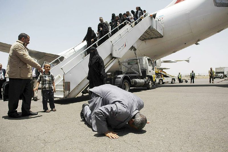 A Yemeni man prays and kisses the ground Wednesday upon arriving at the airport in Sanaa, after being stranded in Egypt when fighting broke out in Yemen. 