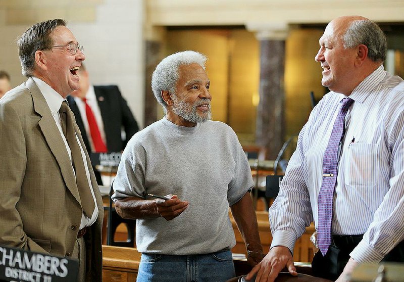 Nebraska Sens. Al Davis, (from left) Ernie Chambers and Rick Kolowski chat Wednesday after Chambers’ bill to abolish the death penalty passed. 