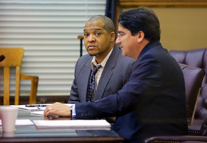 Darrell Dennis (left) sits with attorney Fernando Padilla inside the courtroom of Pulaski County Circuit Judge Chris Piazza at the start of Dennis’ murder trial Wednesday at the Pulaski County Courthouse in Little Rock.