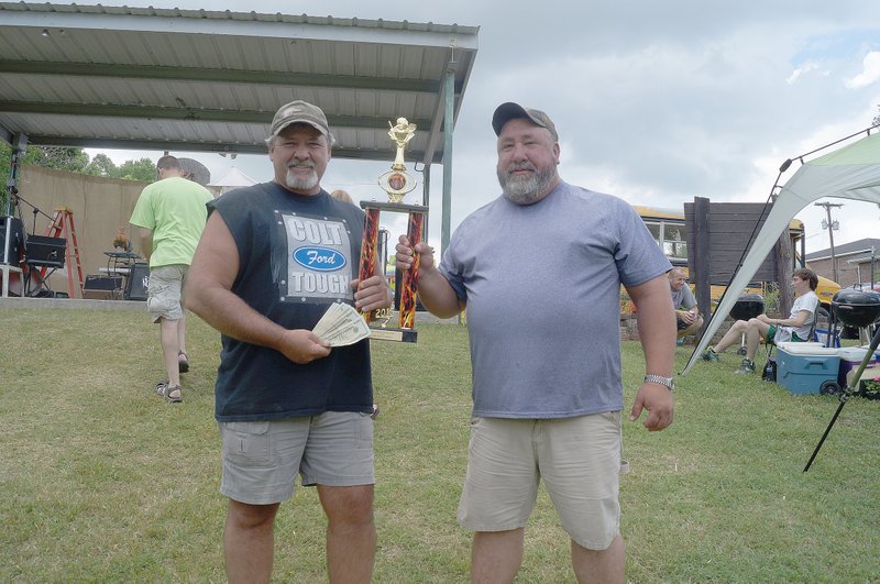 RITA GREENE MCDONALD COUNTY PRESS Bud and Bones, the first place winners for both beef and pork at the Anderson Berries and BBQ Festival. Dan Judd (left) and Jeff Terry, of Rogers, Ark.