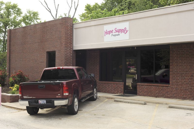 NWA Democrat-Gazette/ANDY SHUPE A pickup sits Tuesday in front of Hope Supply Program at 104 S. Walton Blvd. in Bentonville. The site was closed after a federal lawsuit was filed against the Breast Cancer Society of Mesa, Ariz., which operates the program.