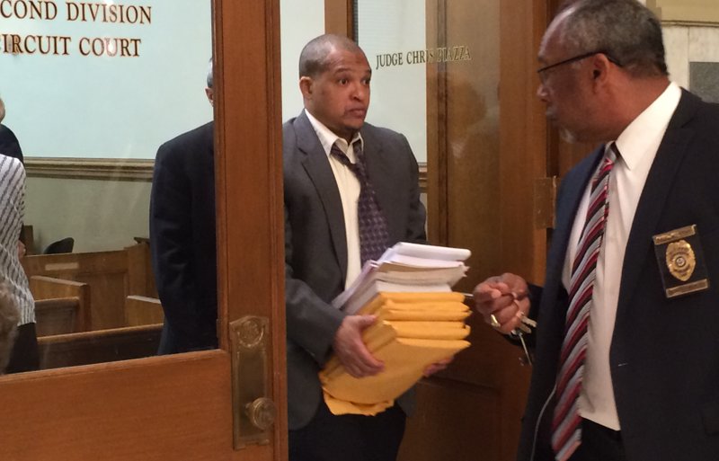 Darrell Dennis exits a Pulaski County Circuit Court room as the jury deliberates on the second day of his murder trial on Thursday, May 21, 2015.