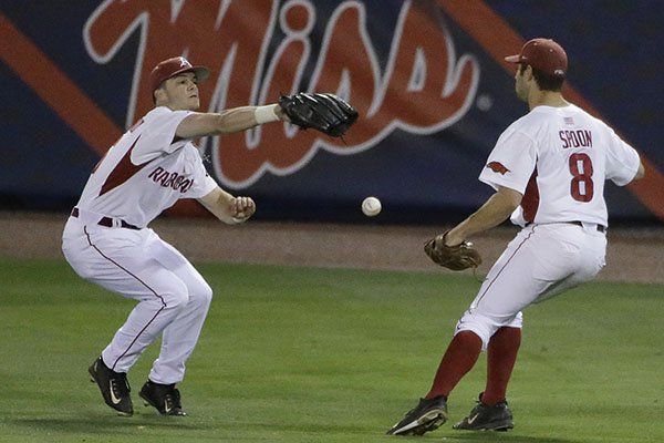 Arkansas' Andrew Benintendi, left, drops a ball hit by LSU during the seventh inning of a Southeastern Conference college baseball tournament game, Thursday, May 21, 2015, in Hoover, Ala. (AP Photo/Brynn Anderson)