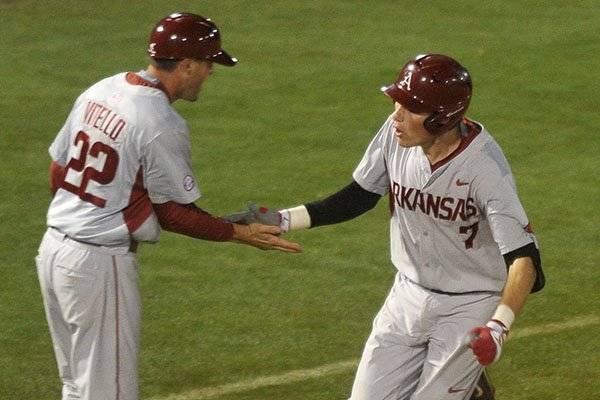 Arkansas third baseman Bobby Wernes (7) celebrates with assistant coach Tony Vitello after hitting a home run during the ninth inning of an SEC Tournament game against Florida on Wednesday, May 20, 2015, at Hoover Metropolitan Stadium in Hoover, Ala. 