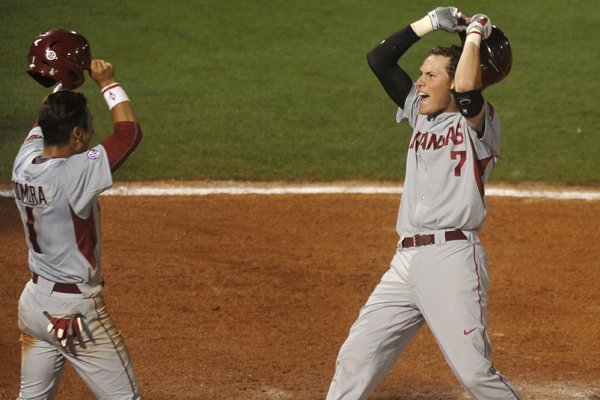 Arkansas' Bobby Wernes is greeted by teammate Rick Nomura after hitting a two-run home run in the ninth inning to take the lead over Florida Wednesday, May 20, 2015, at the SEC baseball tournament in Hoover, Alabama.