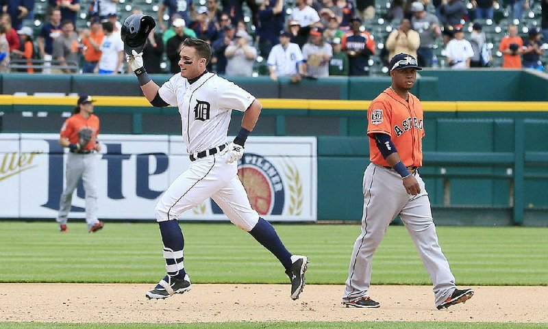 Detroit Tigers' James McCann rounds the bases on his walk-off home run during the 11th inning of a baseball game against the Houston Astros, Thursday, May 21, 2015, in Detroit. 