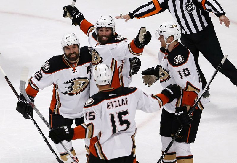 Anaheim Ducks teammates (clockwise, from left) Francois Beauchemin, Patrick Maroon, Corey Perry and Ryan Getzlaf celebrate a goal against the Chicago Blackhawks during Friday’s game in the NHL Western Conference final Thursday in Chicago. The Ducks won 2-1, taking a 2-1 series lead.