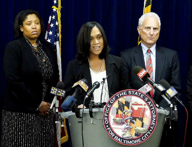 Baltimore State’s Attorney Marilyn Mosby (center) announces Thursday the indictments of six police officers on various charges related to the arrest and death of Freddie Gray. 