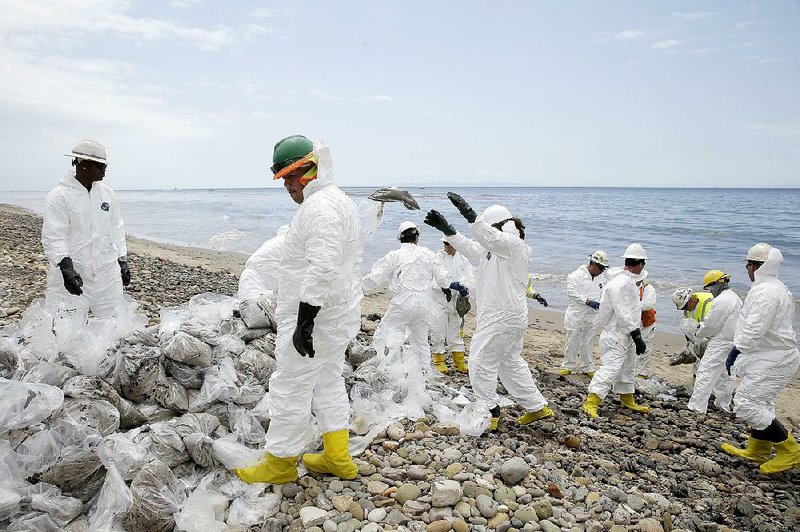 Workers gather oil-contaminated sandbags Thursday at California’s Refugio State Beach as they clean up after a pipeline rupture.