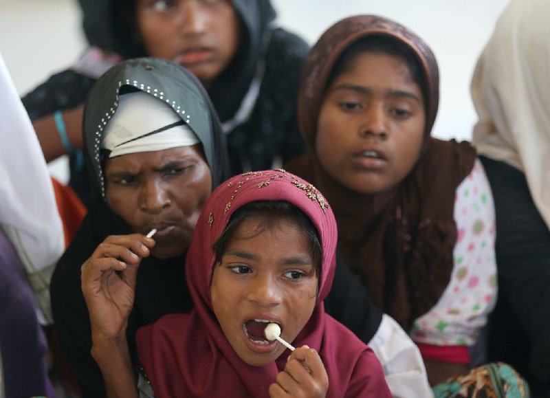 Rescued Rohingya Muslim women wait at a shelter Thursday in Lhoksukon in Indonesia’s Aceh province.