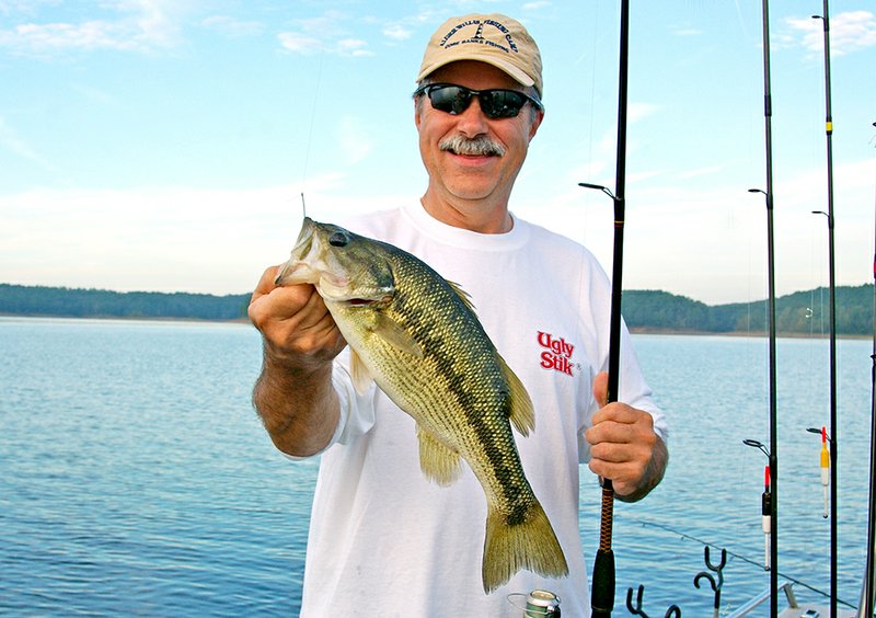 Henry Snuggs of Badin, N.C., is all smiles after catching this trophy Lake Greeson spotted bass on live crawfish bait.