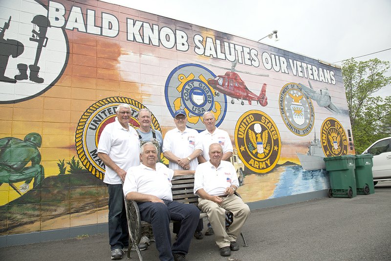 Members of the Bald Knob Veterans Committee pose in front of a mural on the wall of the veterans museum. In the front row, from left, are David Ellis and Travis Case. In the back row are Clois Cox, Perry Wynn, Doyle Wallace and Juke Odom.