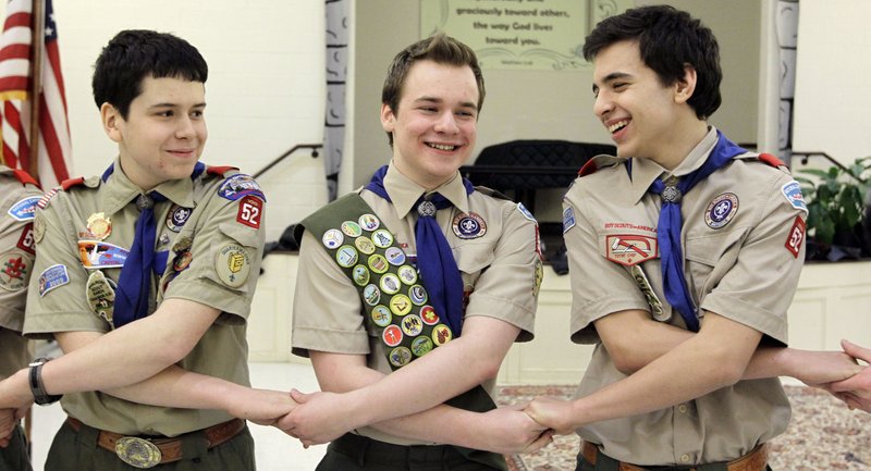 In this Monday, Feb. 10, 2014 file photo, Pascal Tessier, center, takes part in an activity with fellow scouts Matthew Huerta, left, and Michael Fine, right, after he received his Eagle Scout badge in Chevy Chase, Md. On Thursday, April 2, 2015, the Boy Scouts New York chapter announced it hired Tessier as the nations first openly gay Eagle Scout as a summer camp leader in public contrast to the national scouting organizations ban on openly gay adult members. 