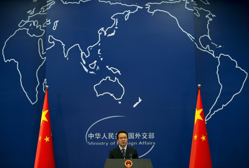 In this May 20, 2014 file photo, Foreign Ministry spokesman Hong Lei speaks during a daily briefing at the Ministry of Foreign Affairs office in Beijing, China. China said Thursday, May 21, 2015 it is entitled to keep watch over airspace and seas surrounding artificial islands it created in the disputed waters of the South China Sea, following a reported exchange in which its navy warned off a U.S. surveillance plane. 