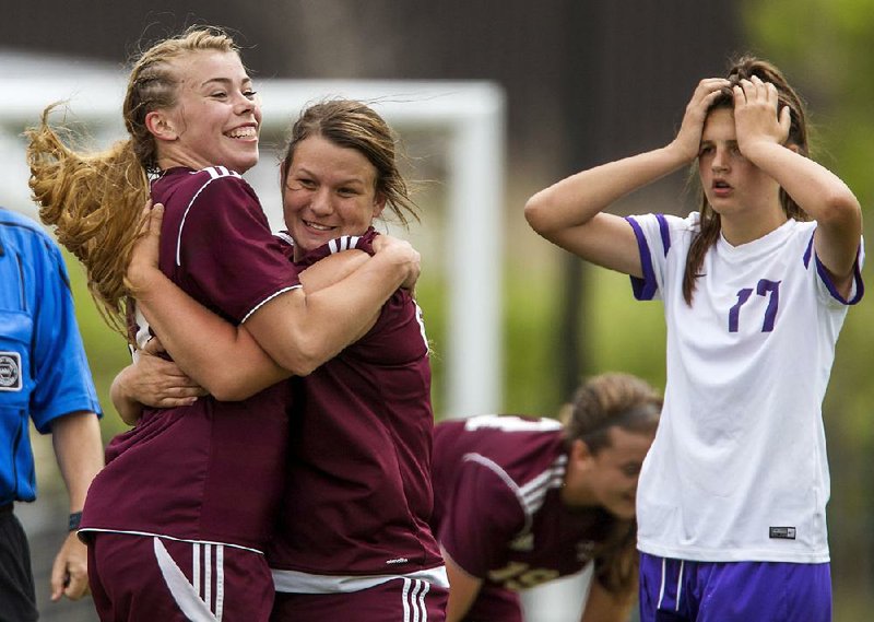 Gentry’s Haley Borgentein-James (left) and Rachel Lawrence (center) celebrate as Central Arkansas Christian’s Sarah Butler looks on in disbelief during the second half of Friday’s Class 4A girls soccer state championship game at Razorback Field. Borgentein-James was one of two Lady Pioneers to score in a 2-0 victory over the Lady Mustangs.