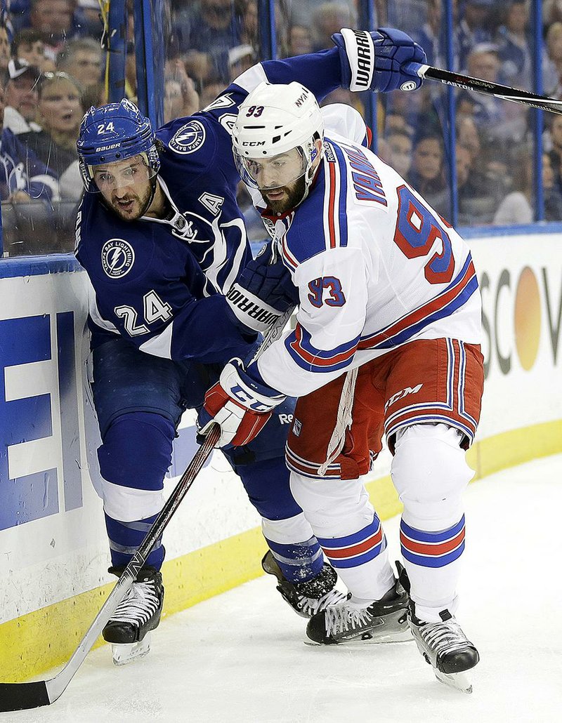 Tampa Bay right wing Ryan Callahan (24) and New York Rangers defenseman Keith Yandle (93) battle for control of the puck during the second period of Game 4 of the NHL Eastern Conference fi nals. The Rangers cruised to a 5-1 victory to tie the series at 2-2.