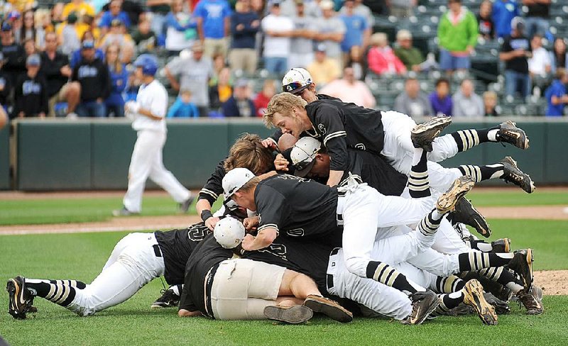 Bentonville players celebrate after beating Conway 6-5 Friday during the Class 7A baseball state championship game at Baum Stadium in Fayetteville. More photos are available at arkansasonline.com/galleries.