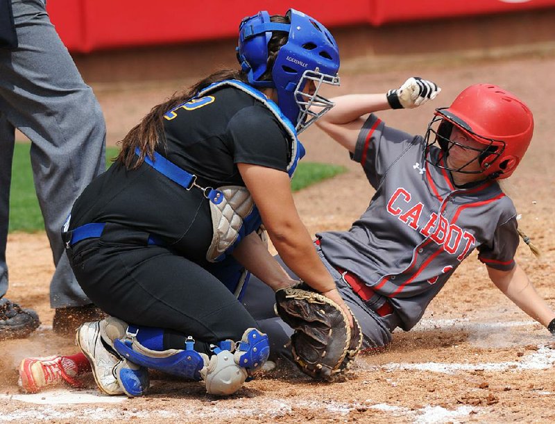 North Little Rock catcher Makenzie Escovedo (left) tries to tag Cabot’s Macee Abbott at the plate during the third inning Friday. The Lady Panthers scored their first run in the inning after two walks, a single and a hit batter.