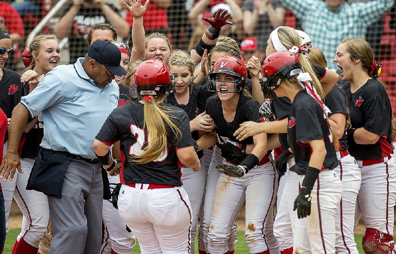 Vilonia players greet senior Buggy Lyons (20) at the plate as she scores on a three-run home run in the fifth inning that gave the Lady Eagles a 5-2 lead over Paragould in the Class 5A softball championship game Friday in Fayetteville.