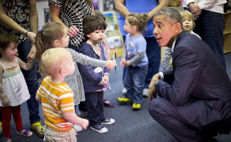 President Barack Obama talks with children Friday during his visit to Gan HaYeled PreSchool at Adas Israel Congregation in Washington.