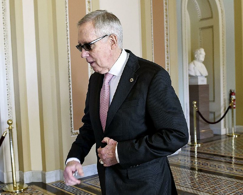 Senate Minority Leader Harry Reid walks back to his office after a meeting Friday with Senate Democrats on Capitol Hill in Washington.