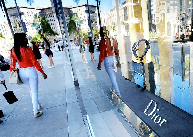 Shoppers walk past a Dior luxury goods shop on Rodeo Drive in Beverly Hills, Calif., in April. Overall consumer prices edged up 0.1 percent in April, the Labor Department said Friday. 