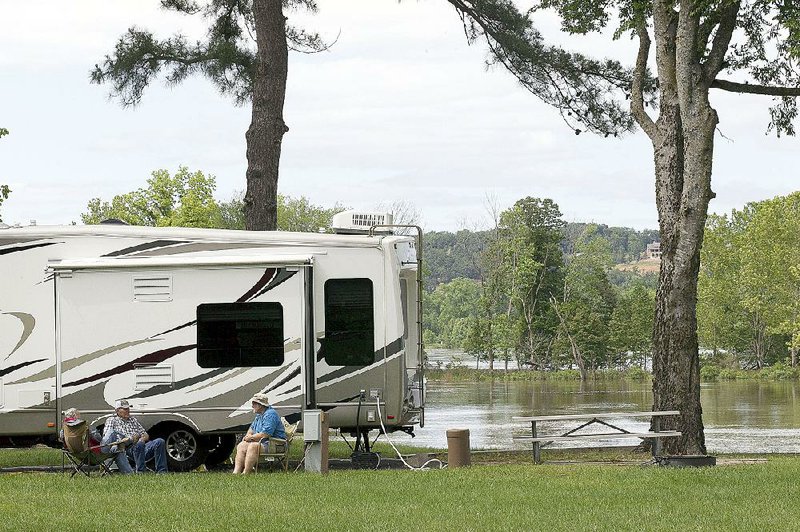 Raymond Frazier, Lawson Mason and Don Bendily of Monroe, La., plan to spend the long weekend at Maumelle Park, where many campers were sent from Toad Suck Park in Conway. The Conway park is closed because of flooding.