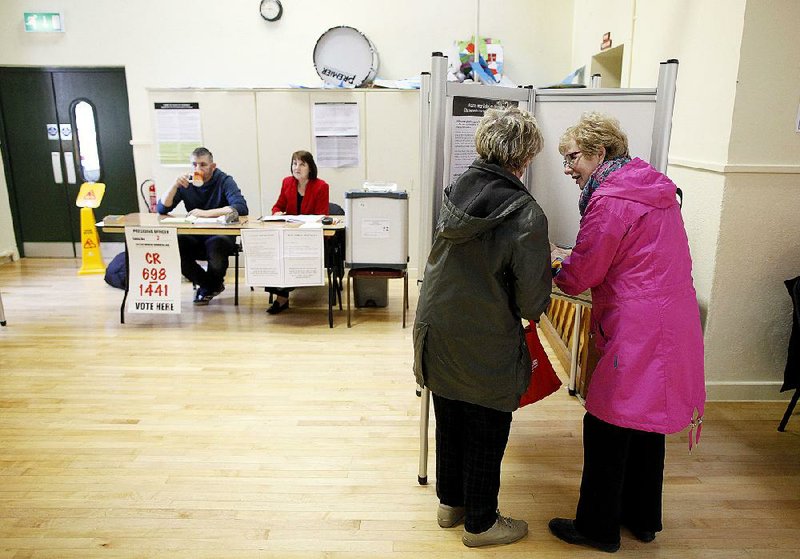 Women cast their votes in a polling station in Malahide, Ireland, on Friday. 