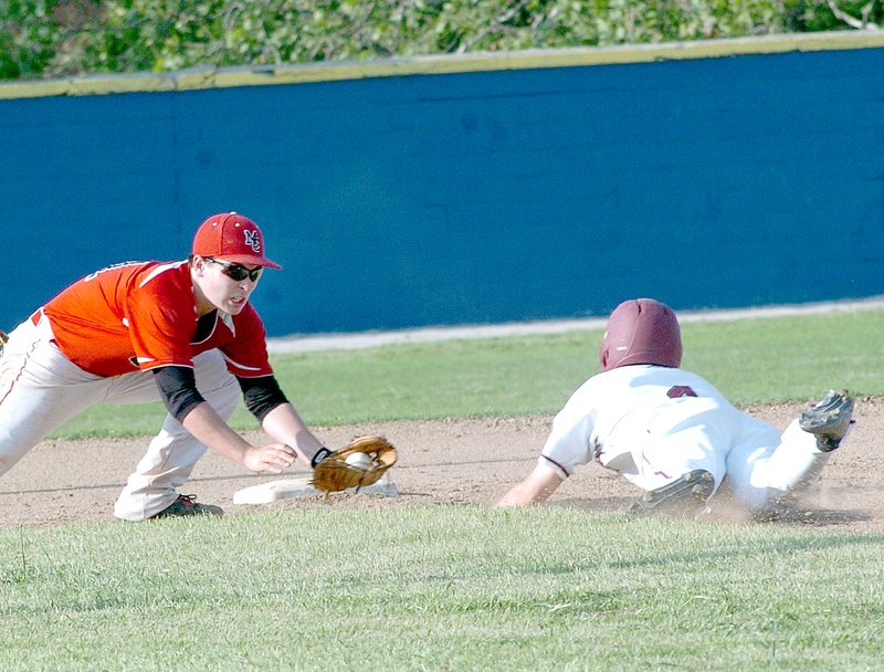 RICK PECK MCDONALD COUNTY PRESS McDonald County second baseman Jake Wilkie is waiting to put the tag on Joplin&#8217;s Spencer Newell during the Mustangs 4-2 loss Saturday in the opening round of the Missouri Class 5 District 12 Baseball Tournament.