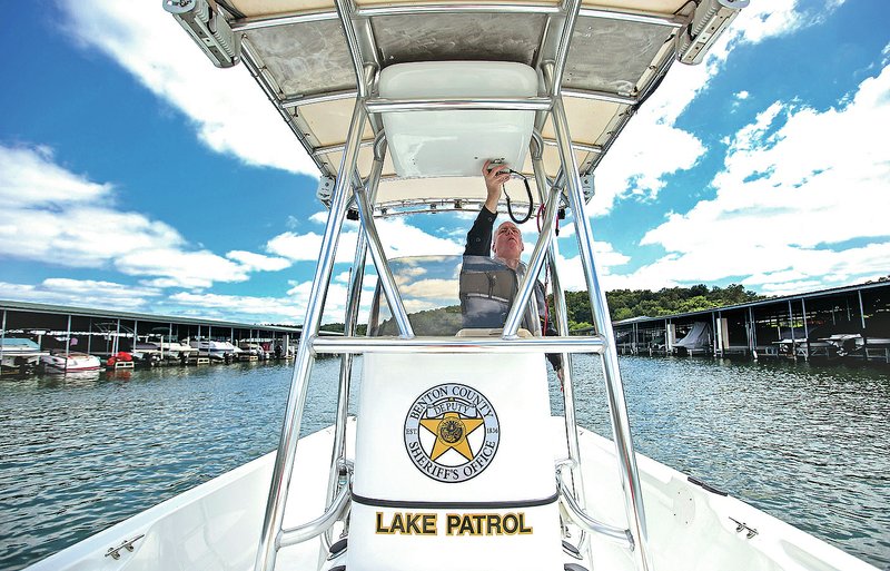 NWA Democrat-Gazette/JASON IVESTER Sgt. Rich Gauert takes one of the Benton County Sheriff&#8217;s Office boats out Thursday from the Prairie Creek Marina at Beaver Lake for patrol.