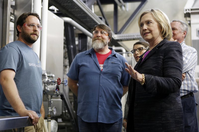 Democratic presidential candidate Hillary Rodham Clinton speaks with employees during a tour of the Smuttynose Brewery, Friday, May 22, 2015, in Hampton, N.H.