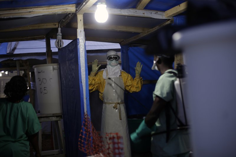 In this Thursday Nov. 20, 2014 file photo, an MSF Ebola heath worker is sprayed as he leaves the contaminated zone at the Ebola treatment centre in Gueckedou, Guinea. Authorities in the country where the Ebola epidemic began are concerned about a new outbreak of cases just as officials hoped the crisis was coming under control.