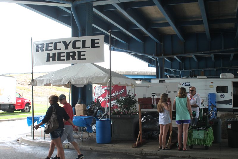 The recycling station at Riverfest, where volunteers crush cans to be hauled off to a recycling facility, is located under the Interstate 30 bridge. 