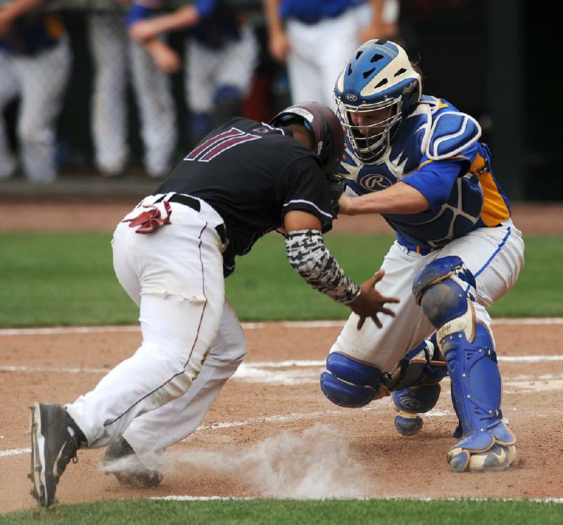 Sheridan catcher Evan Thompson (right) blocks the plate as Benton’s Mike Martindale tries to score during the first inning of Saturday’s 10-9 Yellowjackets victory in the Class 6A baseball state championship game at Baum Stadium in Fayetteville. Martindale was out on the play. 