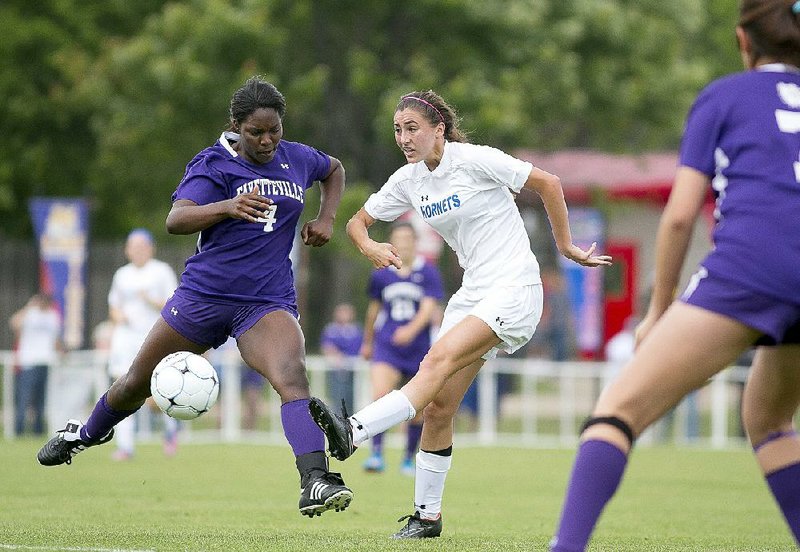 Bryant’s Hadley Dickinson (right), shown trying to clear the ball past Fayetteville’s Katie Sykes, scored on a second-half breakaway to give the Lady Hornets their first state title. 