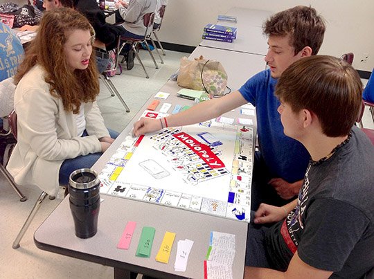 Submitted photo Fountain Lake High School students, from left, Adison Childress, Donnie Arendt and Kyle Dickson, play Monopoly for a lesson in economics in Kenny Shelton's class. Students investigated the impact of changing technology on economic development by looking at leaders of industry who helped make the United States an industrial power. They created a monopoly board and made their own land deeds, money and properties on the board. Andrew Carnegie, Cornelius Vanderbilt, Henry Ford, John Rockefeller and J.P. Morgan were among the leaders discussed.