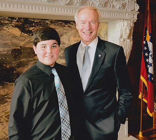 Submitted photo Lakeside High School eighth-grader Riley York, left, was recently chosen by state Rep. John Vines, D-District 25, to serve as a page in the House of Representatives during the 90th General Assembly. York and eight other students toured the Arkansas State Capitol and returned from lunch for photos with their representatives and Gov. Asa Hutchinson, right.