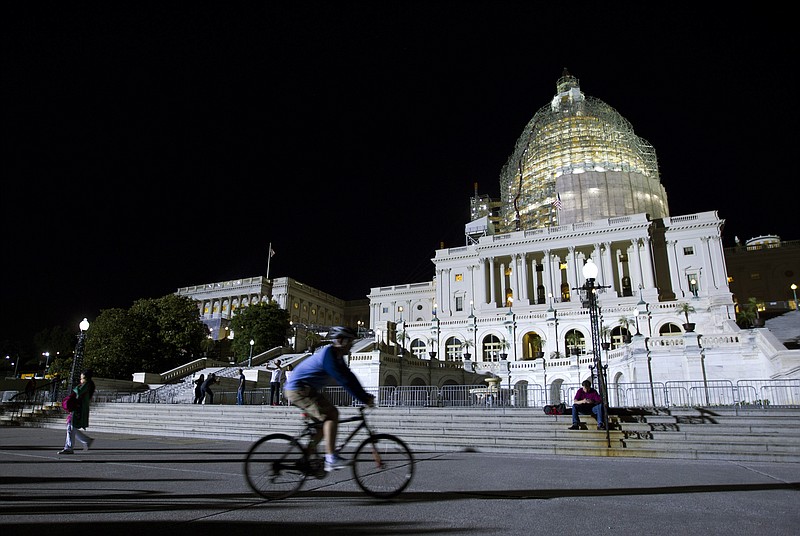 The Associated Press LONG NIGHTS: The U.S. Capitol is illuminated at night as the Senate continues to work late, Friday, May 22, 2015, on Capitol Hill as a pile of important bills await action.