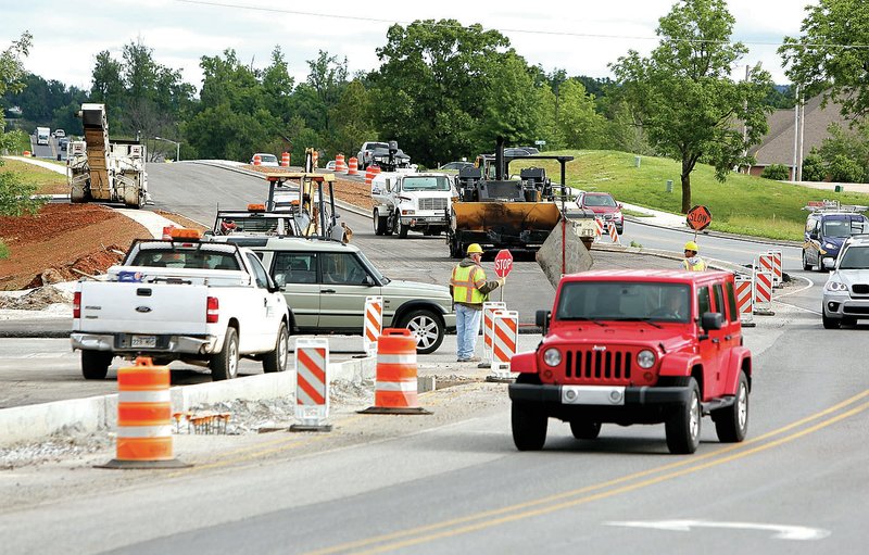 NWA Democrat-Gazette/DAVID GOTTSCHALK Work continues Thursday on Crossover Road near the intersection Zion Road in Fayetteville. Construction on the 2-mile section between Joyce Boulevard and Ivey Lane in Springdale is expected to wrap up this summer. The $9.5 million project is being done by Decco Contractors-Paving of Rogers.