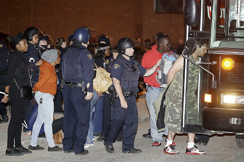 Demonstrators protesting the acquittal of Cleveland police officer Michael Brelo on Saturday are escorted to a bus for transport after their arrest in Cleveland. 