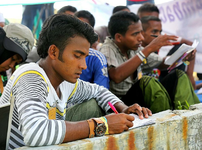 Rohingya men learn a language at a temporary shelter in Kuala Langsa, Aceh province, Indonesia, on Sunday. 