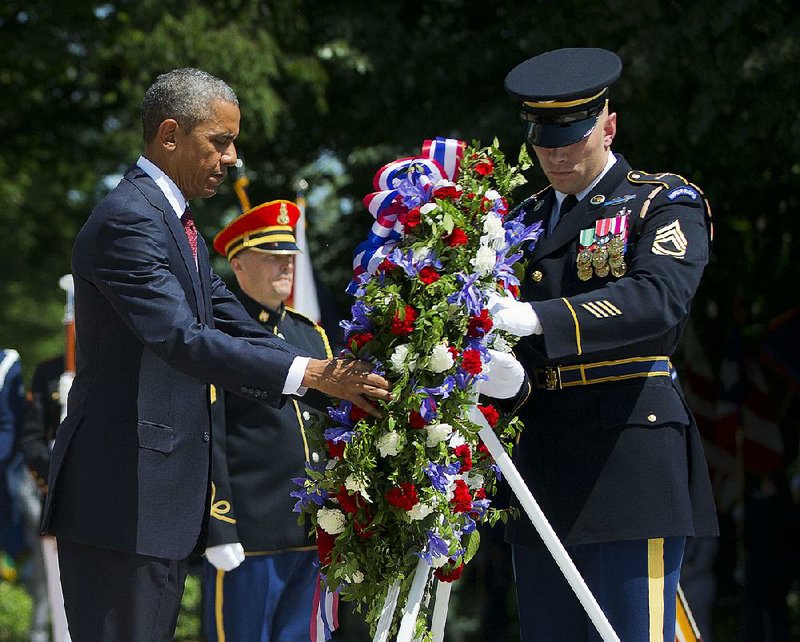 President Barack Obama, with the aid of Sgt. 1st Class John C. Wirth, lays a wreath at the Tomb of the Unknowns on Memorial Day at Arlington National Cemetery in Arlington, Va. 