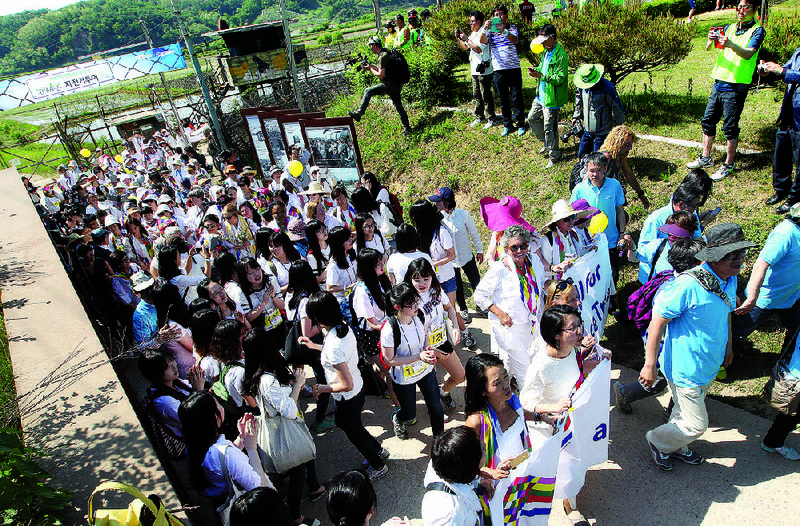 Female activists and South Koreans march to the Imjingak Pavilion near the border village of Panmunjom on Sunday before being denied permission to walk through the truce village. 