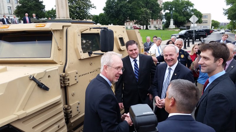 Gov. Asa Hutchinson, Sen. Tom Cotton and U.S. Rep. Bruce Westerman tour a Joint Light Tactical Vehicle Tuesday before a news conference at the state Capitol.