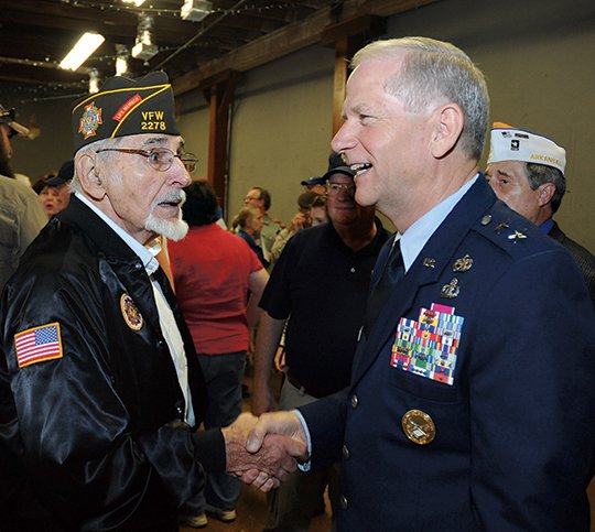 The Sentinel-Record/Mara Kuhn GATHERING IN REMEMBRANCE: Johnny Janise, of Hot Springs, visits with Maj. Gen. Mark H. Berry, Arkansas adjutant general, at the Memorial Day service at The Warehouse Monday morning. Janise served five years in the Navy in the South Pacific.