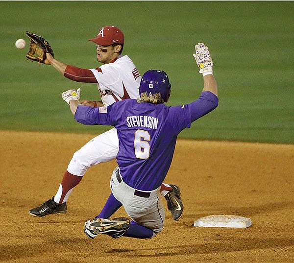 The Associated Press STILLWATER SWINE: Arkansas second baseman Rick Nomura tags out LSU's Andrew Stevenson during the seventh inning of a Southeastern Conference tournament game Thursday at the Hoover Met in Hoover, Ala. The Razorbacks, off a 2-2 finish at the tournament, move on to Oklahoma State's Stillwater Regional, beginning with Oral Roberts at noon Friday on the SEC Network (Resort Channel 79).