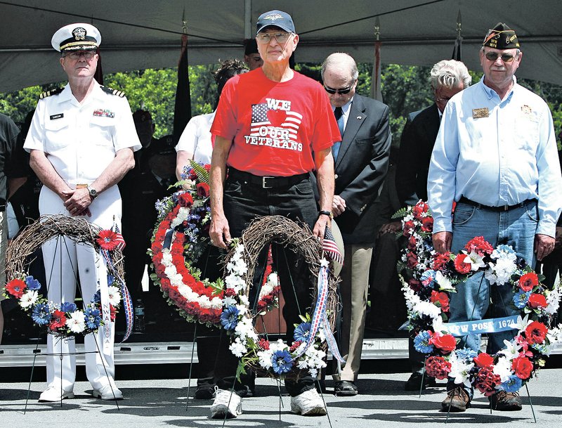  NWA Democrat-Gazette/DAVID GOTTSCHALK Gary Culp (center) with the Northwest Arkansas Veterans Coalition participates in the Memorial Wreath Recognition service Monday at Fayetteville National Cemetery. The cemetery was the site of a Memorial Day ceremony honoring veterans and families of veterans.
