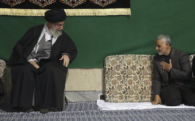 In this Friday, March 27, 2015 file photo released by the official website of the office of the Iranian supreme leader, commander of Iran's Quds Force, Qassem Soleimani, right, greets Supreme Leader Ayatollah Ali Khamenei while attending a religious ceremony in a mosque at his residence in Tehran, Iran. 