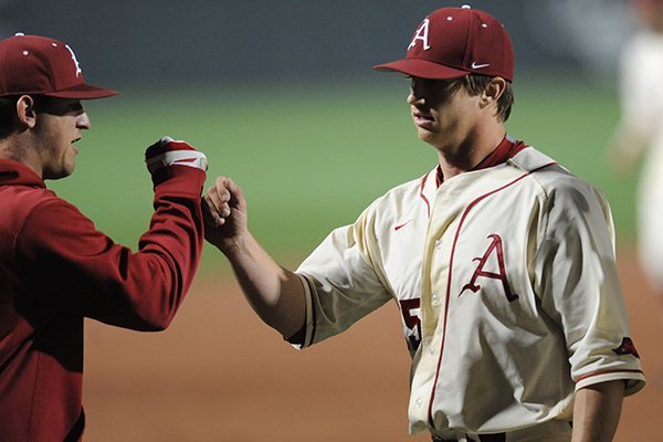 Dominic Taccolini of Arkansas is congratulated after the final out of the sixth inning against LSU Thursday, March 19, 2015, at Baum Stadium in Fayetteville.